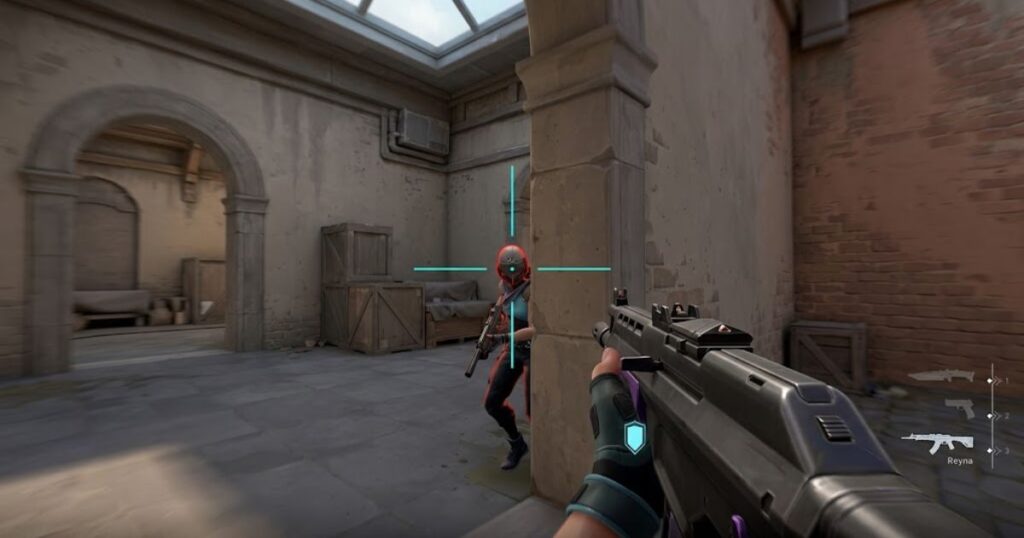 A Valorant player holding a rifle with the crosshair positioned at an enemy's head level during a tactical gunfight