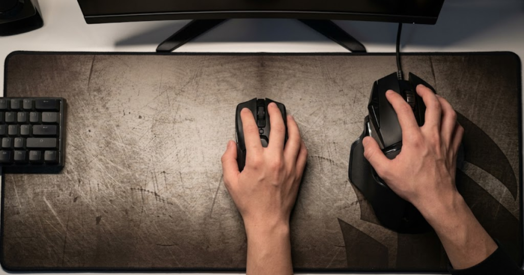 A player with a small hand struggling to comfortably control an oversized gaming mouse while comparing it to a better-fitting alternative.