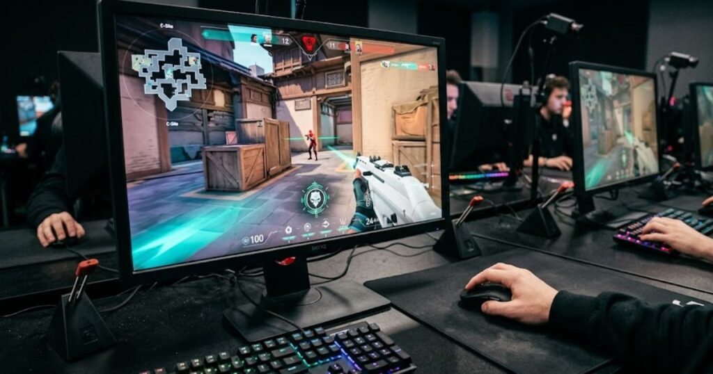 Professional Valorant player using a gaming mouse while performing a flick shot during a tactical FPS match on a competitive gaming setup