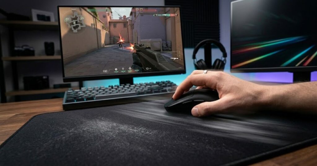 A lightweight gaming mouse being moved quickly across a large mouse pad during gameplay.