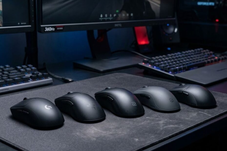 Several ergonomic gaming mice arranged on a gaming desk, designed for palm grip FPS players seeking comfort and stable aiming performance.