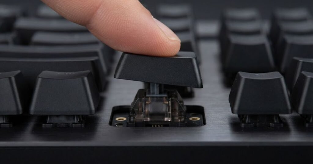 Close-up of a finger pressing a mechanical gaming keyboard key