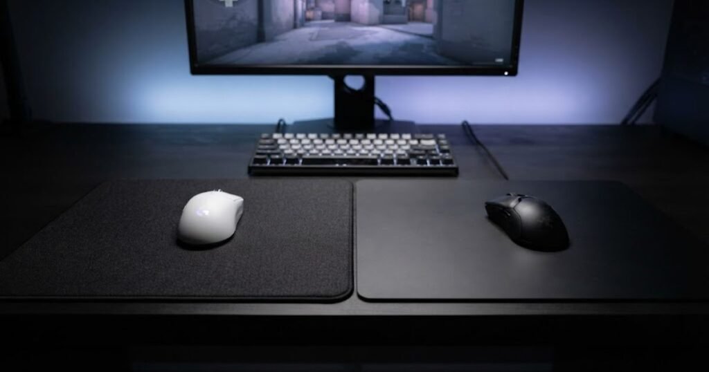 A textured cloth mouse pad and a smooth hard mouse pad with gaming mice shown side by side